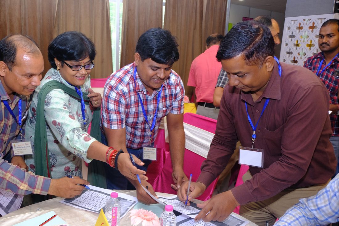 Education officials working through materials at a capacity-building workshop